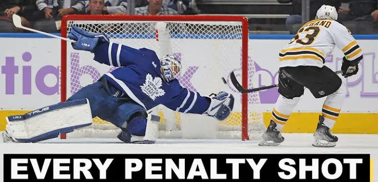 Hockey goalie making a save during a penalty shot.