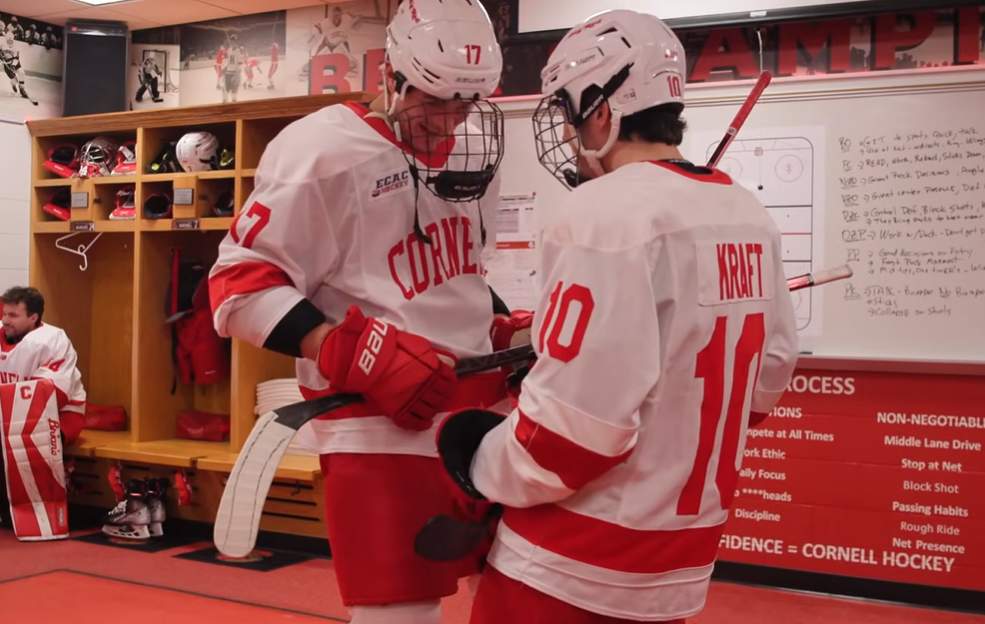 Hockey players preparing in locker room.
