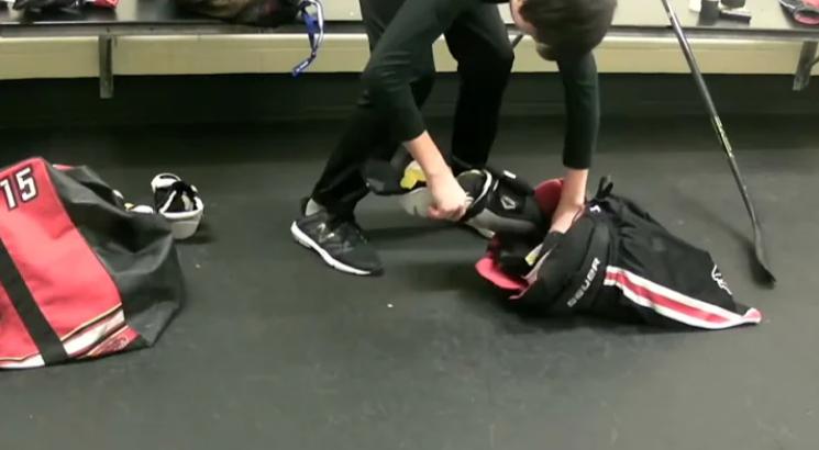 A player is packing his Hockey bag
